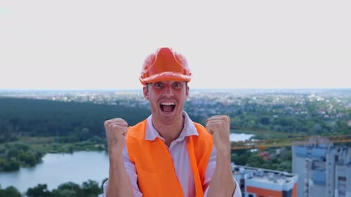 Construction Worker Cheering Success on a Building Rooftop