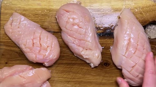 Raw Chicken Breasts Prepared on Wooden Cutting Board