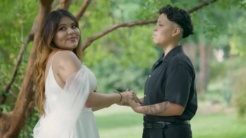 Lesbian Couple Holding Hands in Lush Park Setting