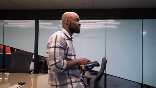 Man uses tablet in conference room