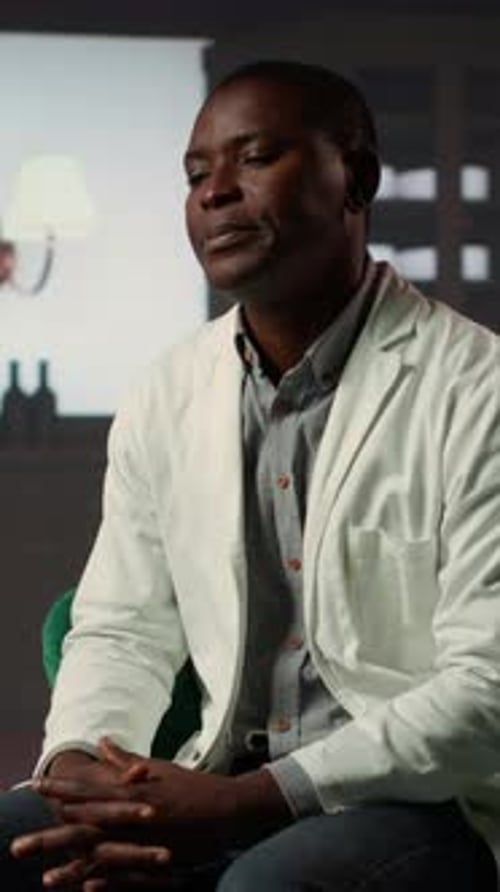 Vertical Video Professional Counselor in Therapy Session with Black Medic Experiencing Trauma