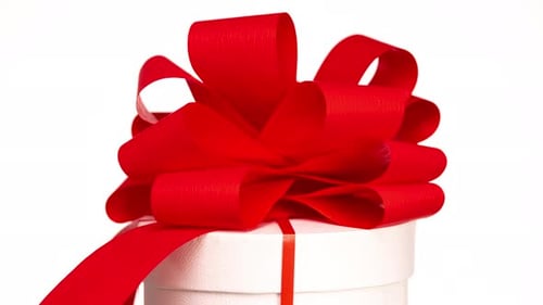 Close Up Of Birthday Gift Wrapped with Red Bow