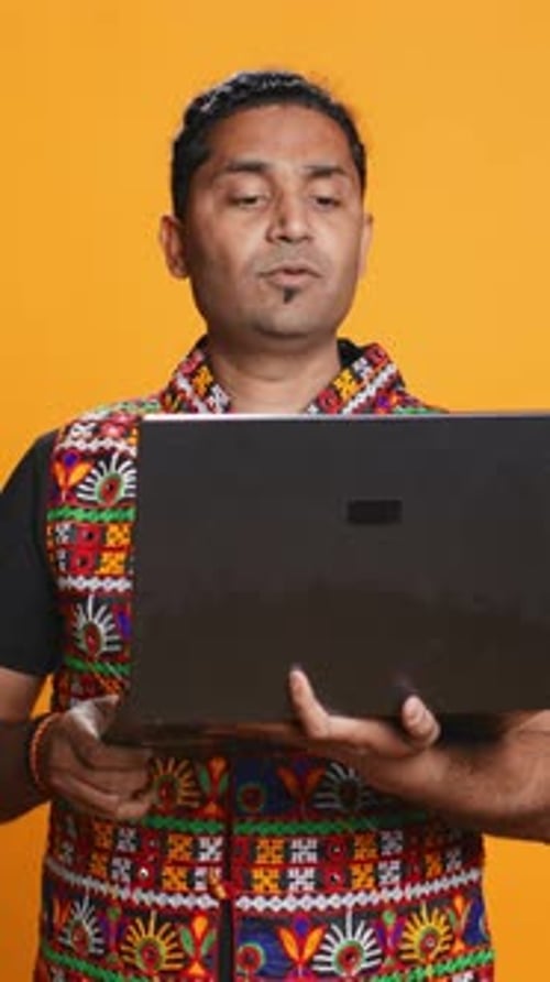 Vertical Video Man with Friends in Teleconference Meeting Using Laptop Studio Background