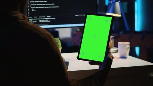 Software Developer Programming in Home Office with Green Screen Tablet