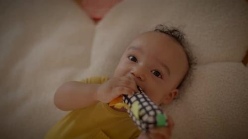 Baby Lying Down Holding Toy Close Up