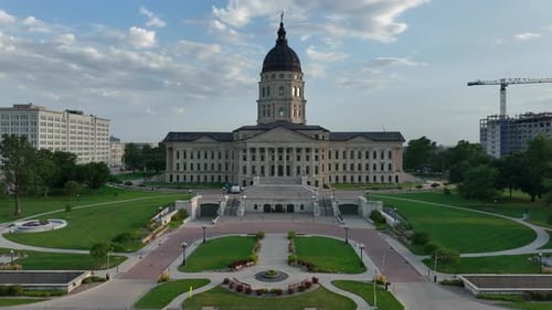 Kansas state capitol building standing tall in downtown Topeka, KS. Aerial push in shot over capitol