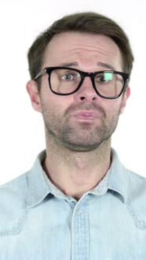 Man Wearing Glasses Reacts to Bad News