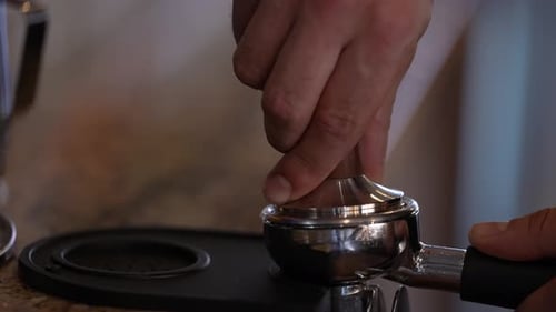 Man Tamping Espresso Grounds in Portafilter
