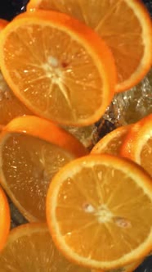 Sliced Orange Circles Fall Into the Water Filmed on a Highspeed Camera at 1000 Fps