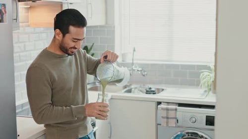 Healthy, man and drink protein shake or smoothie for energy, wellness and health lifestyle in home