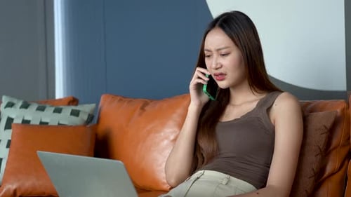Agitated Young Woman Talking on the Phone