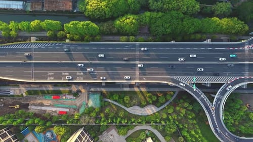 Aerial View of the Busy Highway with Numerous Vehicles Navigating a Complex Interchange