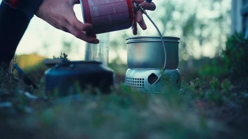 Hiker Cooking On A Portable Camping Gas Stove. Close-up Shot