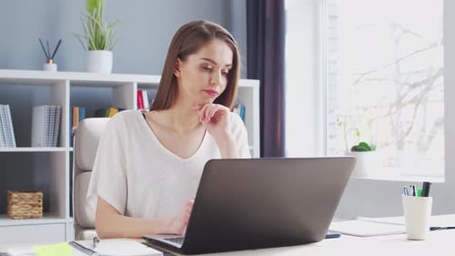 Young Woman Works at Home Office Using Computer Workplace of Female Entrepreneur Freelancer or