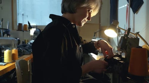 Woman Sewing Fabric on an Industrial Sewing Machine