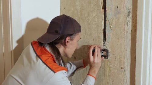 Installing an electrical outlet. 2 Shots.