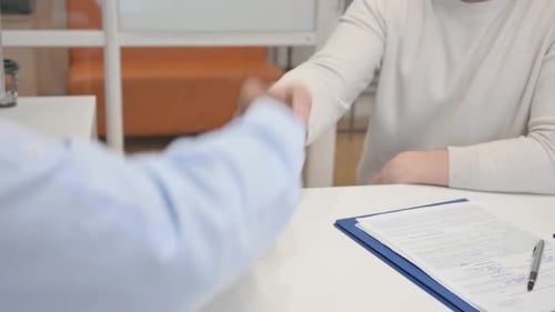 Close Up of Handshake by Business People