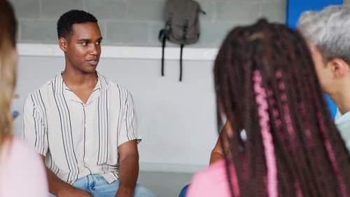 Young Group of Teenage High School Students Discussing in Classroom with Teacher