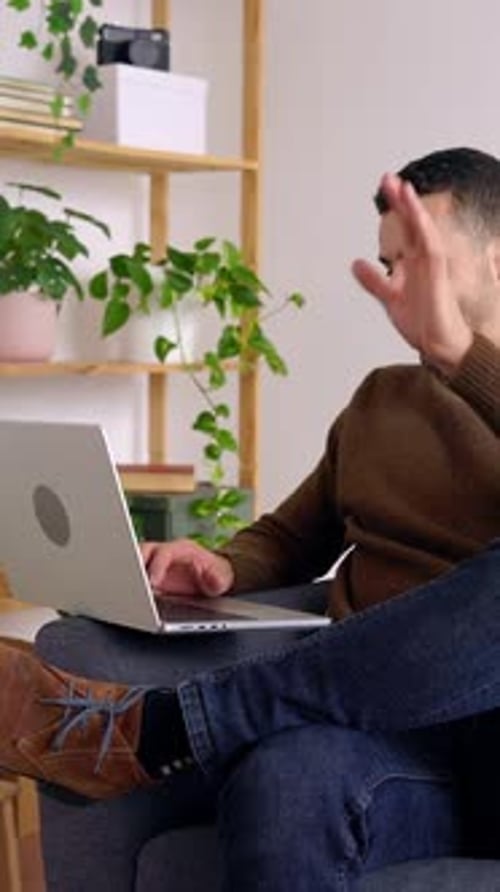 Adult Video Conferencing On Laptop at Home