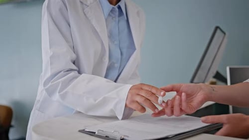 Doctor Hands Signing Documents in Healthcare Office Closeup Woman Practitioner