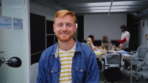Portrait of an Office Smiling Young Man and Looking at Camera