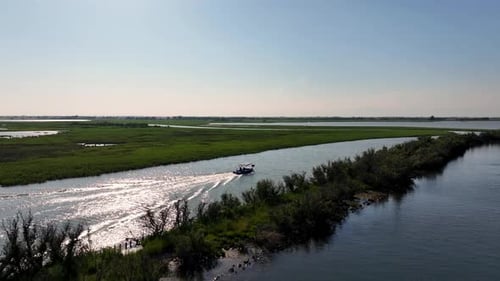 drone view of a motorboat in the marano's lagoon on sunset