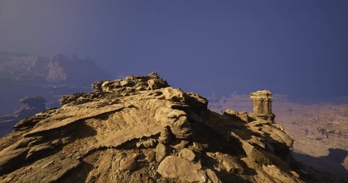 Rocky Landscape Under Clear Blue Sky with Distant Formations at Twilight