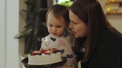 Mother and Child Celebrate Birthday with Cake