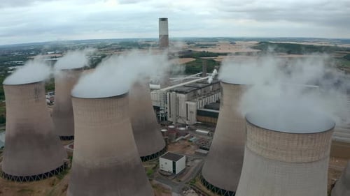 Establishing drone shot of coal fired power plant and cooling towers