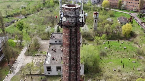 Aerial view of abandoned ruined factory tube. Apocalypsis crashed city.