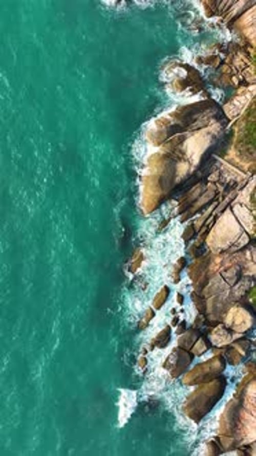 Explore the stunning rocky coastline and turquoise waters. Vertical video