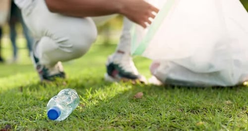 Cleaning, volunteer and man in park with plastic for community service, recycling