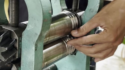 Metal Piece Going Through Rolling Machine Close Up