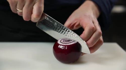 Hands Cut Fresh Red Onion with Knife