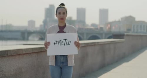 Portrait of Biracial Young Lady Holding Me Too Banner Protesting Against Sexual Abuse and Aggression
