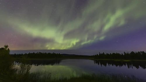 Aurora Borealis timelapse reflecting on lake near Kiruna, Sweden