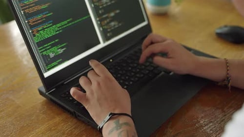 Developers Hands Type Code on Laptop in Office Setting Programmer Debugs Software Taps on Keyboard