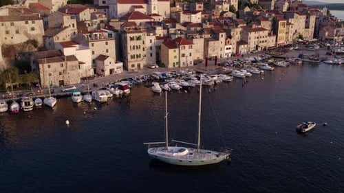 Luftaufnahme von Stadt, Kirche, Küste, Boot bei Sonnenuntergang, Kroatien.
