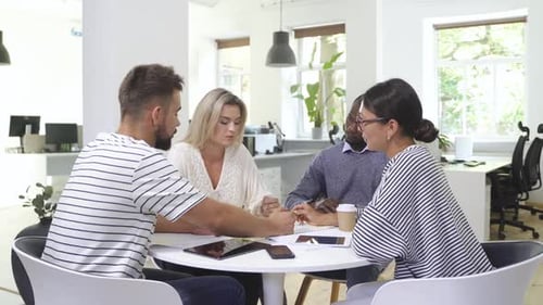 Team Meeting Around Table in Modern Office
