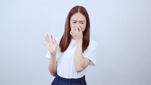 The girl was disgusted. Hold your nose so you don't get an unpleasant stench.