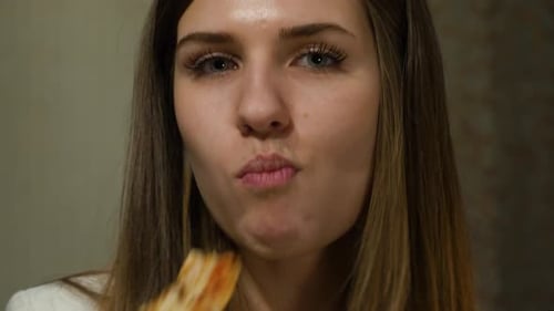 Woman Eats Pizza Slice, Close Up Shot