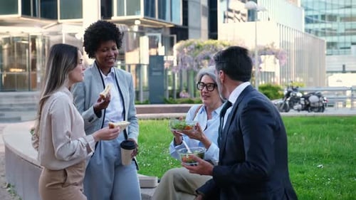 Colleagues Enjoy Lunch Break Together in Urban Setting