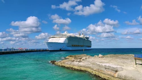 Massive Cruise Ship Docked at Tropical Island Port on a Sunny Day