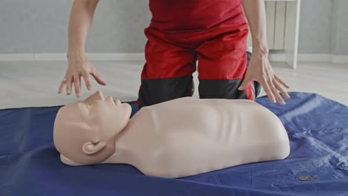 Woman Demonstrates CPR on Training Mannequin