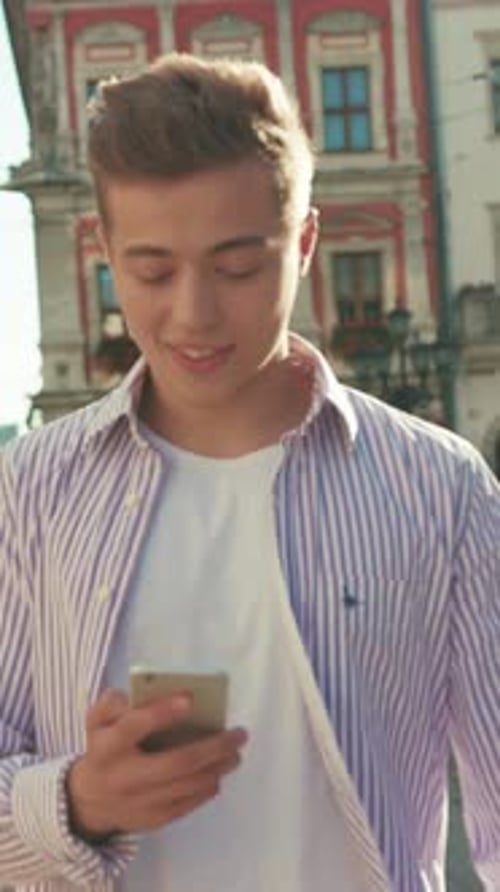 Portrait Young Happy Man Walk on Street Use Phone Look Around Smile Sunlight Cute Work Mobile Gadget