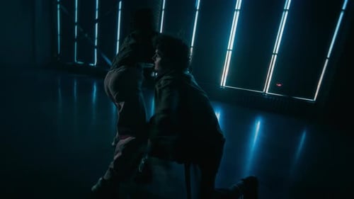 Couple of Dancers Performing Choreography in Dark Studio