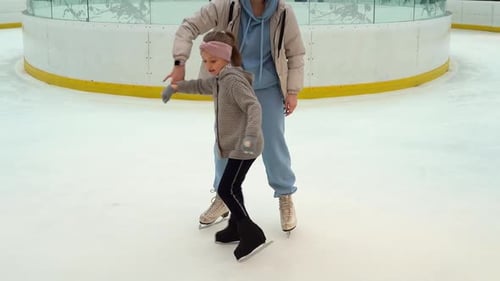 Figure Skating Coach Works with Girl at Ice Rink Childrens Sport
