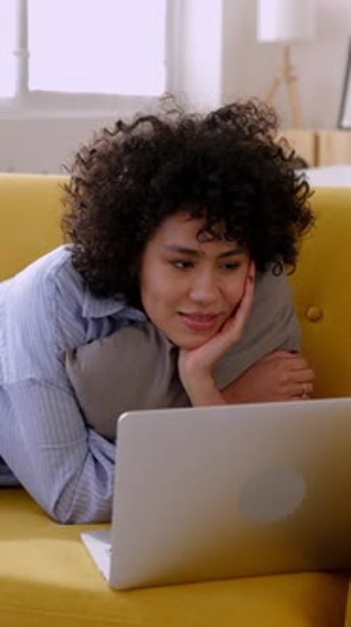 Happy Young Hispanic Latin Woman Having Fun Watching Funny Videos on Laptop