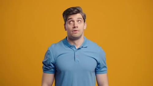 Man Rolling Eyes against Yellow Background