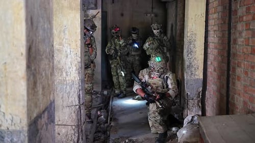 Camouflaged Group Armed with Rifles in an Urban Area